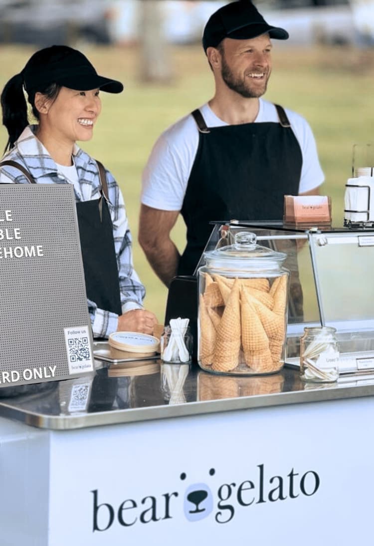 An image of two people in front of a gelato cart