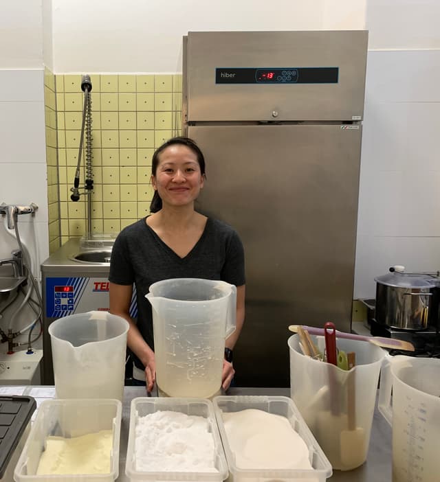 An image of one person smiling at a gelato store