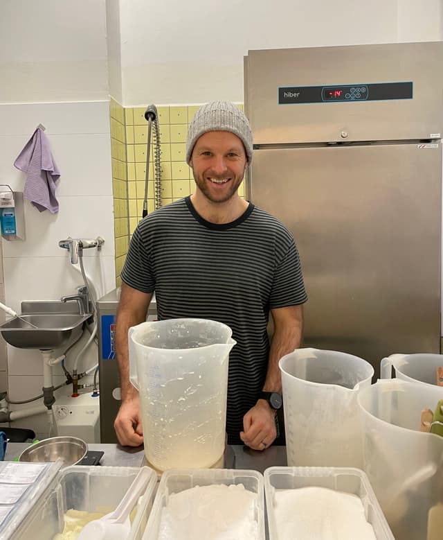 An image of one person smiling at a gelato store